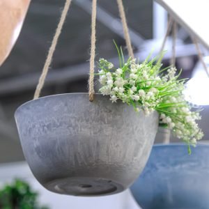Hanging planter for flowers. Interior design element and garden decor made of natural materials